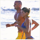Man and Woman Running on a Beach