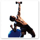 Tony Horton Leaning on Beachbody® Balance Ball Holding a Dumbbell